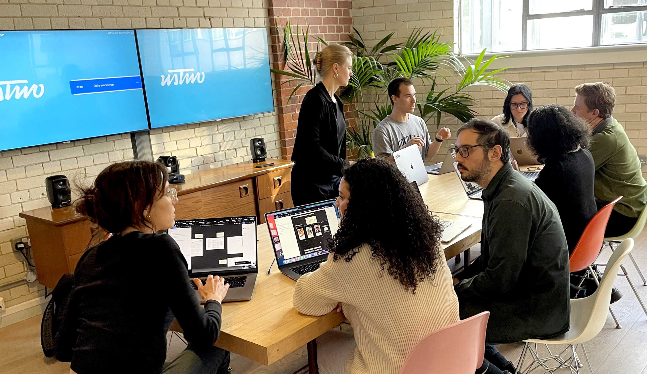 The team with laptops meeting around a table at ustwo’s studio